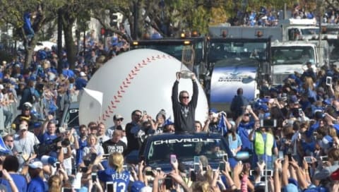 Nov 3, 2015; Kansas City, MO, USA; Kansas City Royals manager Ned Yost (3) holds the Commissioners Trophy up to fans during the World Series parade route at Union Station. Mandatory Credit: Denny Medley-USA TODAY Sports