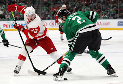 DALLAS, TEXAS – JANUARY 03: Jamie Oleksiak #2 of the Dallas Stars skates the puck against Adam Erne #73 of the Detroit Red Wings in the second period at American Airlines Center on January 03, 2020 in Dallas, Texas. (Photo by Ronald Martinez/Getty Images)