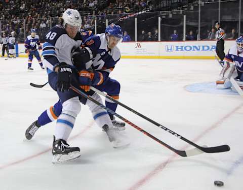 NEW YORK, NEW YORK – DECEMBER 04: Brendan Lemieux #48 of the Winnipeg Jets attempts to get around Adam Pelech #3 of the New York Islanders during the first period at the Barclays Center on December 04, 2018 in the Brooklyn borough of New York City. (Photo by Bruce Bennett/Getty Images)