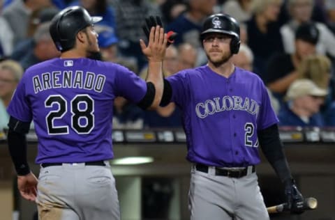 Jun 2, 2017; San Diego, CA, USA; Colorado Rockies shortstop Trevor Story (27) congratulates third baseman Nolan Arenado (28) after Arenado scored during the third inning on a single by left fielder Ian Desmond (not pictured) at Petco Park. Mandatory Credit: Jake Roth-USA TODAY Sports