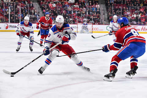 MONTREAL, QC – FEBRUARY 27: Mika Zibanejad #93 of the New York Rangers skates the puck against Ben Chiarot #8 of the Montreal Canadiens during the first period at the Bell Centre on February 27, 2020 in Montreal, Canada. (Photo by Minas Panagiotakis/Getty Images)