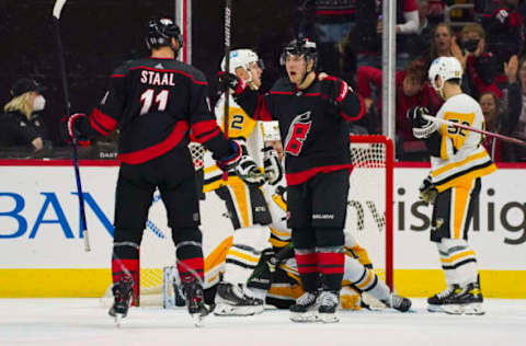 Mar 4, 2022; Raleigh, North Carolina, USA; Carolina Hurricanes center Jordan Staal (11) is congratulated by right wing Jesper Fast (71) after his goal against the Pittsburgh Penguins during the second period at PNC Arena. Mandatory Credit: James Guillory-USA TODAY Sports