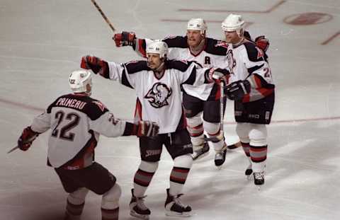 4 Jun 1998: Rob Ray #32 (C) surrounded by Paul Kruse #24 (L) and Wayne Primeau #22 (R) of the Buffalo Sabres in action during the Eastern Conference Finals game against the Washington Capitals at the Marine Midland Arena in Buffalo, New York. The Capita