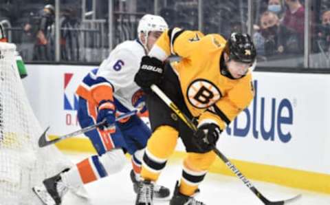 Apr 15, 2021; Boston, Massachusetts, USA; Boston Bruins left wing Jake DeBrusk (74) tries to gain control of the puck in front of New York Islanders defenseman Ryan Pulock (6) during the second period at TD Garden. Mandatory Credit: Bob DeChiara-USA TODAY Sports