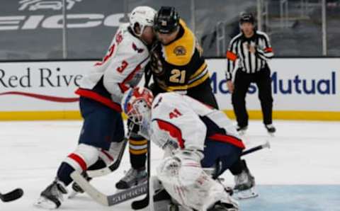 Apr 18, 2021; Boston, Massachusetts, USA; Washington Capitals defenseman Nick Jensen (3) tries to clear out Boston Bruins left wing Nick Ritchie (21) as the puck is loose under goaltender Vitek Vanecek (41) during the third period at TD Garden. Mandatory Credit: Winslow Townson-USA TODAY Sports