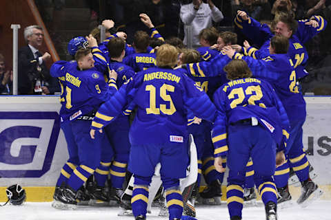 Sweden players celebrate their 4-3 win after a goal by Lucas Raymond (Photo by Erik MARTENSSON / TT News Agency / AFP) / Sweden OUT (Photo credit should read ERIK MARTENSSON/AFP via Getty Images)