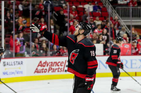 RALEIGH, NC – JANUARY 03: Carolina Hurricanes Defenceman Dougie Hamilton (19) makes a young fans day by tossing him a puck during warmups before an NHL game between the Carolina Hurricanes and the Washington Capitals on January 3, 2020, at the PNC Arena in Raleigh, NC. (Photo by John McCreary/Icon Sportswire via Getty Images)