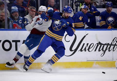 Feb 19, 2022; Buffalo, New York, USA; Colorado Avalanche center Nazem Kadri (91) and Buffalo Sabres right wing Alex Tuch (89) go after a loose puck during the second period at KeyBank Center. Mandatory Credit: Timothy T. Ludwig-USA TODAY Sports