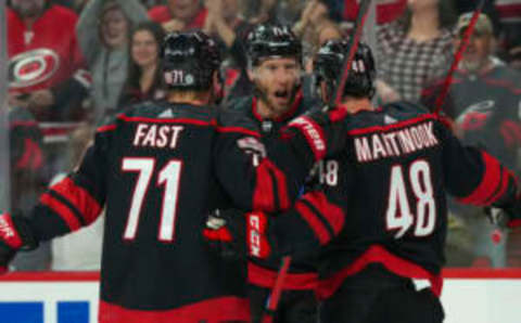 Mar 25, 2023; Raleigh, North Carolina, USA; Carolina Hurricanes center Jordan Staal (11) is congratulated by left wing Jordan Martinook (48) and right wing Jesper Fast (71) after his goal against the Toronto Maple Leafs during the first period at PNC Arena. Mandatory Credit: James Guillory-USA TODAY Sports