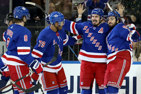 Mar 25, 2022; New York, New York, USA; New York Rangers left wing Chris Kreider (20) celebrates his goal against the Pittsburgh Penguins with defenseman Jacob Trouba (8) and defenseman K’Andre Miller (79) and center Mika Zibanejad (93) during the first period at Madison Square Garden. Mandatory Credit: Brad Penner-USA TODAY Sports