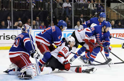 NEW YORK, NEW YORK – APRIL 29: Erik Haula #56 of the New Jersey Devils is checked by Braden Schneider #4 of the New York Rangers in Game Six of the First Round of the 2023 Stanley Cup Playoffs at Madison Square Garden on April 29, 2023, in New York, New York. The Rangers defeated the Devils 5-2. (Photo by Bruce Bennett/Getty Images)