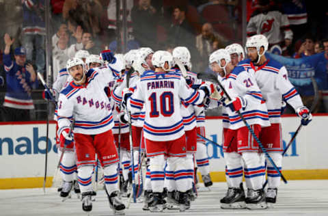 NEWARK, NEW JERSEY – NOVEMBER 18: Vincent Trocheck #16, Artemi Panarin #10 and Barclay Goodrow #21 of the New York Rangers celebrate the win over the New Jersey Devils at Prudential Center on November 18, 2023 in Newark, New Jersey. The New York Rangers defeated the New Jersey Devils 5-3. (Photo by Elsa/Getty Images)