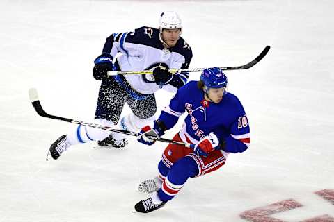 NEW YORK, NEW YORK – OCTOBER 03: Dmitry Kulikov #7 of the Winnipeg Jets and Artemi Panarin #10 of the New York Rangers skate down the ice during their game at Madison Square Garden on October 03, 2019 in New York City. (Photo by Emilee Chinn/Getty Images)