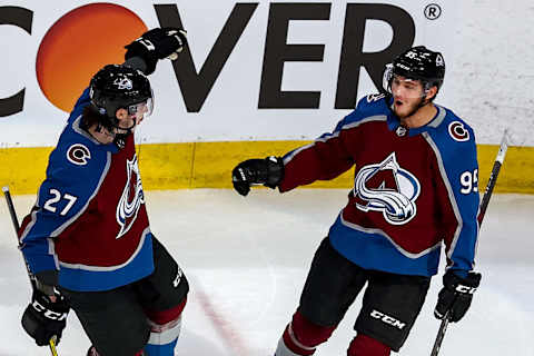 Andre Burakovsky #95 of the Colorado Avalanche is congratulated by his teammate, Ryan Graves (Photo by Bruce Bennett/Getty Images)