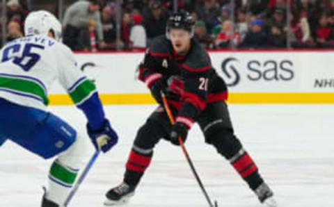 Jan 15, 2023; Raleigh, North Carolina, USA; Carolina Hurricanes center Sebastian Aho (20) skates with the puck against the Vancouver Canucks during the first period at PNC Arena. Mandatory Credit: James Guillory-USA TODAY Sports