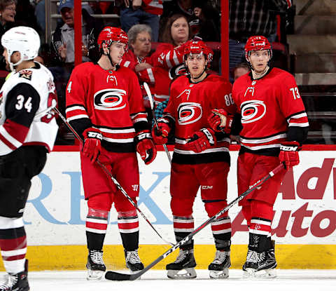 RALEIGH, NC – MARCH 22: Teuvo Teravainen #86 of the Carolina Hurricanes scores a goal and celebrates with teammates Haydn Fleury #4 and Valentin Zykov #73 during an NHL game against the Arizona Coyotes on March 22, 2018 at PNC Arena in Raleigh, North Carolina. (Photo by Gregg Forwerck/NHLI via Getty Images)