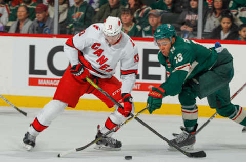 SAINT PAUL, MN – NOVEMBER 16: Warren Foegele #13 of the Carolina Hurricanes and Jordan Greenway #18 of the Minnesota Wild battle for the puck during the game at the Xcel Energy Center on November 16, 2019 in Saint Paul, Minnesota. (Photo by Bruce Kluckhohn/NHLI via Getty Images)