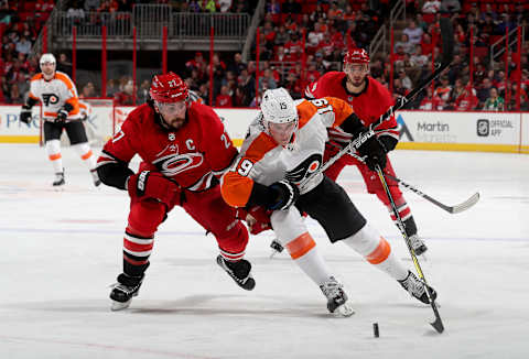 RALEIGH, NC – FEBRUARY 6: Justin Faulk #27 of the Carolina Hurricanes and Nolan Patrick #19 of the Philadelphia Flyers battle to control the puck during an NHL game on February 6, 2018 at PNC Arena in Raleigh, North Carolina. (Photo by Gregg Forwerck/NHLI via Getty Images)