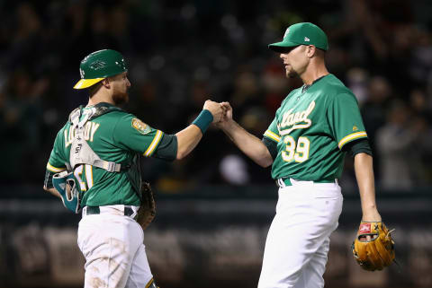 OAKLAND, CA – SEPTEMBER 07: Jonathan Lucroy #21 and Blake Treinen #39 of the Oakland Athletics celebrate after they beat the Texas Rangers at Oakland Alameda Coliseum on September 7, 2018 in Oakland, California. (Photo by Ezra Shaw/Getty Images)