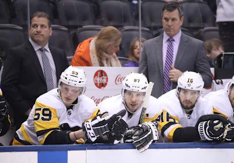 Mar 10, 2018; Toronto, Ontario, CAN; Pittsburgh Penguins center Jake Guentzel (59) and center Sidney Crosby (87) and right wing Josh Jooris (16) look on from the bench as assistant coach Mark Recchi and head coach Mike Sullivan look on against the Toronto Maple Leafs at Air Canada Centre. The Maple Leafs beat the Penguins 5-2. Mandatory Credit: Tom Szczerbowski-USA TODAY Sports