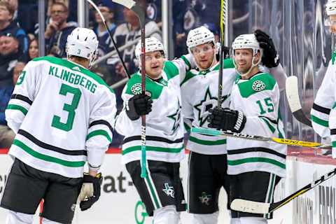 WINNIPEG, MB – MARCH 25: John Klingberg #3 of the Dallas Stars joins teammates Mattias Janmark #13, Radek Faksa #12 and Blake Comeau #15 as they celebrate a second period goal against the Winnipeg Jets at the Bell MTS Place on March 25, 2019 in Winnipeg, Manitoba, Canada. (Photo by Jonathan Kozub/NHLI via Getty Images)