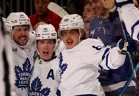 Auston Matthews #34 of the Toronto Maple Leafs is congratulated by teammates Mitchell Marner #16 and William Nylander #88 after Matthews scored the game winning goal (Photo by Elsa/Getty Images)