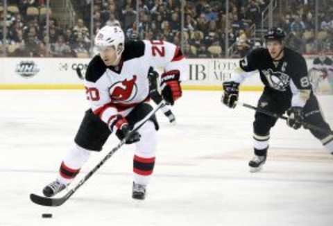 Jan 26, 2016; Pittsburgh, PA, USA; New Jersey Devils right wing Lee Stempniak (20) skates with the puck ahead of Pittsburgh Penguins center Sidney Crosby (87) during the first period at the CONSOL Energy Center. Mandatory Credit: Charles LeClaire-USA TODAY Sports