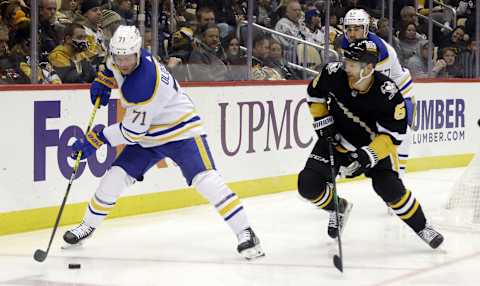 Dec 17, 2021; Pittsburgh, Pennsylvania, USA; Buffalo Sabres left wing Victor Olofsson (71) moves the puck against Pittsburgh Penguins defenseman Mike Matheson (5) during the third period at PPG Paints Arena. The Penguins won 3-2 in overtime. Mandatory Credit: Charles LeClaire-USA TODAY Sports