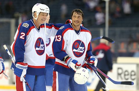 WINNIPEG, MANITOBA – OCTOBER 22: Dave Ellett #2 and Teemu Selanne #13 of the Winnipeg Jets alumni skate off the ice after action against the Edmonton Oilers alumni during the 2016 Tim Hortons NHL Heritage Classic alumni hockey game on October 22, 2016 at Investors Group Field in Winnipeg, Manitoba, Canada. (Photo by Jason Halstead /Getty Images)