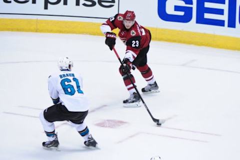 Oct 2, 2015; Glendale, AZ, USA; Arizona Coyotes defenseman Oliver Ekman-Larsson (23) passes to left wing Anthony Duclair (10) for an assist as San Jose Sharks defenseman Justin Braun (61) defends during an exhibition overtime period at Gila River Arena. Mandatory Credit: Matt Kartozian-USA TODAY Sports