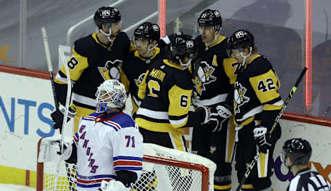 Mar 7, 2021; Pittsburgh, Pennsylvania, USA; The Pittsburgh Penguins celebrate a goal by center Evgeni Malkin (71) against New York Rangers goaltender Keith Kinkaid (71) during the third period at PPG Paints Arena. The Penguins won 5-1. Mandatory Credit: Charles LeClaire-USA TODAY Sports