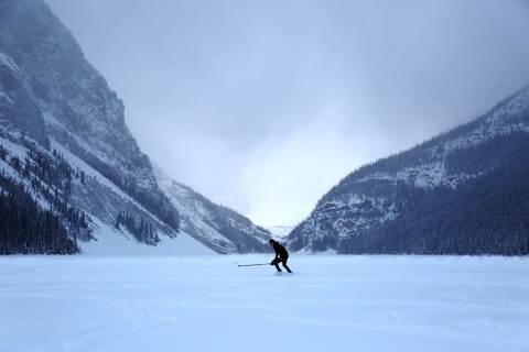 LAKE LOUISE, CANADA – JANUARY 3 : A man ice skates with a hockey stick on a frozen Lake Louise at Banff National Park in Alberta, Canada on January 3, 2021. (Photo by Mert Alper Dervis/Anadolu Agency via Getty Images)