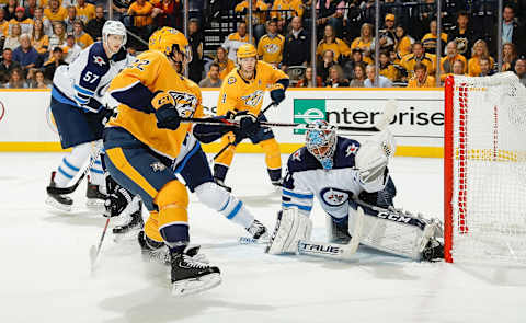 NASHVILLE, TN – OCTOBER 11: Connor Hellebuyck #37 of the Winnipeg Jets makes a glove save against Kevin Fiala #22 of the Nashville Predators at Bridgestone Arena on October 11, 2018 in Nashville, Tennessee. (Photo by John Russell/NHLI via Getty Images)