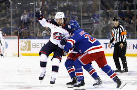 NEW YORK, NEW YORK – OCTOBER 23: Ryan Carpenter #22 of the New York Rangers checks Johnny Gaudreau #13 of the Columbus Blue Jackets during the third period at Madison Square Garden on October 23, 2022, in New York City. The Blue Jackets defeated the Rangers 5-1. (Photo by Bruce Bennett/Getty Images)