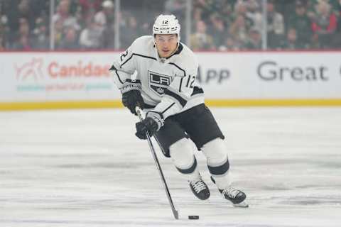 Feb 21, 2023; Saint Paul, Minnesota, USA; Los Angeles Kings left wing Trevor Moore (12) brings the puck into the Minnesota Wild zone in the first period at Xcel Energy Center. Mandatory Credit: Matt Blewett-USA TODAY Sports