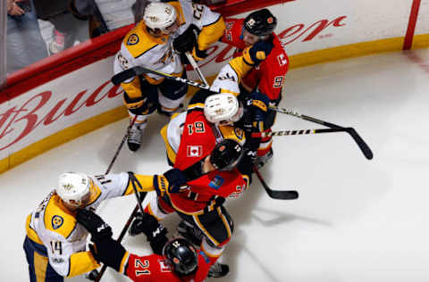 CALGARY, AB – DECEMBER 16: Teammates of the Calgary Flames and the Nashville Predators gets into a scuffle during an NHL game on December 16, 2017 at the Scotiabank Saddledome in Calgary, Alberta, Canada. (Photo by Gerry Thomas/NHLI via Getty Images)