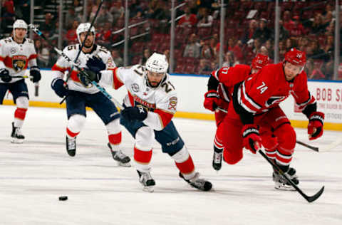 SUNRISE, FL – FEBRUARY 21: Vincent Trocheck #21 of the Florida Panthers skates for possession against Jaccob Slavin #74 of the Carolina Hurricanes at the BB&T Center on February 21, 2019 in Sunrise, Florida. (Photo by Eliot J. Schechter/NHLI via Getty Images)