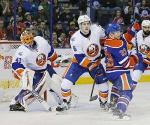 Feb 28, 2016; Edmonton, Alberta, CAN; Edmonton Oilers forward Matt Hendricks (23) and New York Islanders defensemen Ryan Pulock (6) battle in front New York Islanders goaltender Jaroslav Halak (41) during the third period at Rexall Place. Mandatory Credit: Perry Nelson-USA TODAY Sports