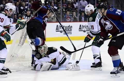 Dec 7, 2015; Denver, CO, USA; Colorado Avalanche left wing Gabriel Landeskog (92) collides with Minnesota Wild goalie Darcy Kuemper (35) in a overtime period at Pepsi Center. The Colorado Avalanche defeated the Minnesota Wild 2-1 in overtime. Mandatory Credit: Ron Chenoy-USA TODAY Sports