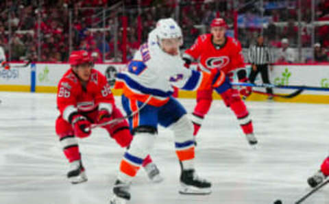 Apr 19, 2023; Raleigh, North Carolina, USA; New York Islanders center Jean-Gabriel Pageau (44) takes a shot against Carolina Hurricanes left wing Teuvo Teravainen (86) during the second period in game two of the first round of the 2023 Stanley Cup Playoffs at PNC Arena. Mandatory Credit: James Guillory-USA TODAY Sports