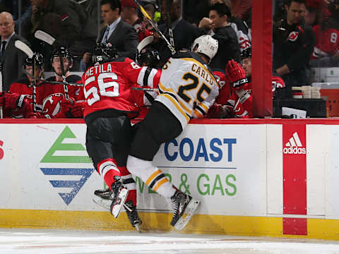 NEWARK, NJ – MARCH 21: Blake Pietila #56 of the New Jersey Devils checks Brandon Carlo #25 of the Boston Bruins during the third period at the Prudential Center on March 21, 2019 in Newark, New Jersey. The Bruins defeated the Devils 5-1. (Photo by Andy Marlin/NHLI via Getty Images)