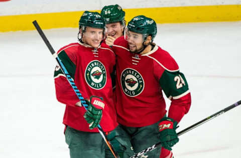 Nov 23, 2016; Saint Paul, MN, USA; Minnesota Wild defenseman Jonas Brodin (25) celebrates his goal with defenseman Matt Dumba (24) and forward Mikael Granlund (64) during the third period against the Winnipeg Jets at Xcel Energy Center. The Wild defeated the Jets 3-1. Mandatory Credit: Brace Hemmelgarn-USA TODAY Sports