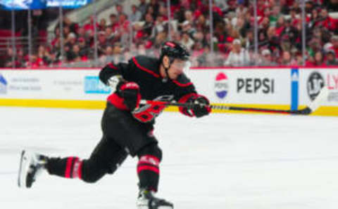 Oct 11, 2023; Raleigh, North Carolina, USA; Carolina Hurricanes defenseman Dmitry Orlov (7) takes a shot against the Ottawa Senators during the third period at PNC Arena. Mandatory Credit: James Guillory-USA TODAY Sports