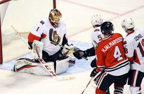 NHL Power Rankings: Ottawa Senators goalie Mike Condon (1) makes a save against Chicago Blackhawks defenseman Niklas Hjalmarsson (4) during the third period at the United Center. Ottawa defeats Chicago 4-3. Mandatory Credit: Mike DiNovo-USA TODAY Sports