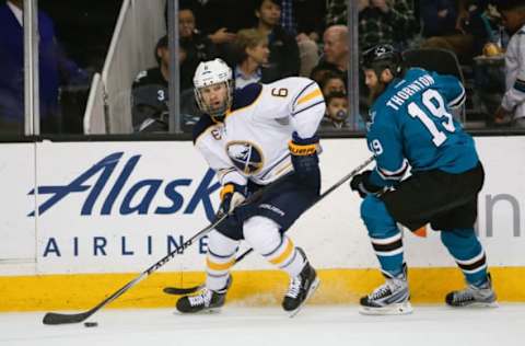 Mar 14, 2017; San Jose, CA, USA; Buffalo Sabres defenseman Cody Franson (6) controls the puck against San Jose Sharks center Joe Thornton (19) during the first period at SAP Center at San Jose. The San Jose Sharks defeated the Buffalo Sabres 4-1. Mandatory Credit: Stan Szeto-USA TODAY Sports