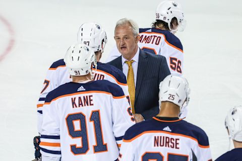 May 26, 2022; Calgary, Alberta, CAN; Calgary Flames head coach Darryl Sutter and Edmonton Oilers center Connor McDavid (97) exchange words after the game in game five of the second round of the 2022 Stanley Cup Playoffs at Scotiabank Saddledome. Mandatory Credit: Sergei Belski-USA TODAY Sports