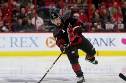 RALEIGH, NC – APRIL 18: Justin Faulk #27 of the Carolina Hurricanes looks to pass the puck in Game Four of the Eastern Conference First Round against the Washington Capitals during the 2019 NHL Stanley Cup Playoffs on April 18, 2019 at PNC Arena in Raleigh, North Carolina. (Photo by Gregg Forwerck/NHLI via Getty Images)