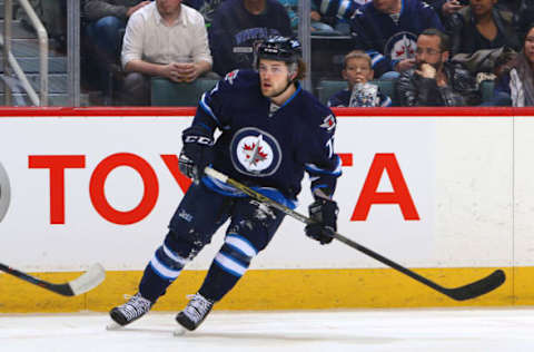 WINNIPEG, MB – MARCH 22: Chase De Leo #77 of the Winnipeg Jets keeps an eye on the play during the first-period action against the Vancouver Canucks at the MTS Centre on March 22, 2016, in Winnipeg, Manitoba, Canada. The Jets defeated the Canucks 2-0. (Photo by Jonathan Kozub/NHLI via Getty Images)