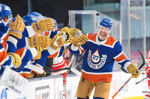 EDMONTON, CANADA - OCTOBER 29: Brett Kulak #27 of the Edmonton Oilers celebrates with the bench after scoring the team`s first goal against the Calgary Flames during the first period of the 2023 Tim Hortons NHL Heritage Classic at Commonwealth Stadium on October 29, 2023 in Edmonton, Alberta, Canada. (Photo by Derek Leung/Getty Images)