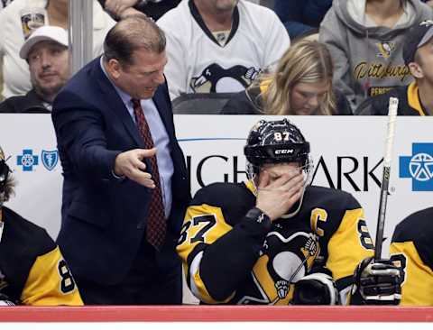 Mar 11, 2018; Pittsburgh, PA, USA; /pen assistant coach Mark Recchi (L) talks to center Sidney Crosby (87) on the bench against the Dallas Stars during the second period at PPG PAINTS Arena. Mandatory Credit: Charles LeClaire-USA TODAY Sports